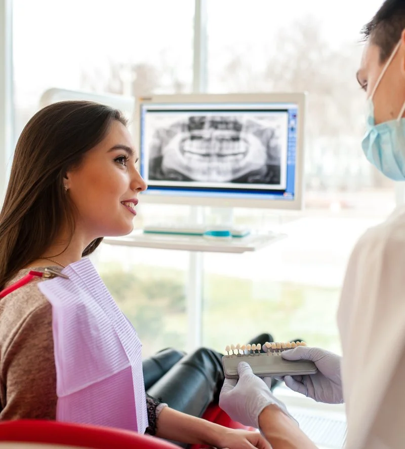 Patient discussing full mouth reconstruction treatment plan in Deerfield Beach dental office